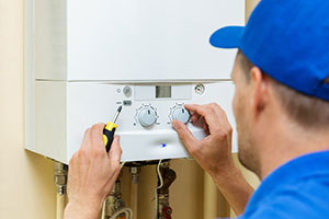 plumber servicing boiler to prevent carbon monoxide poisoning