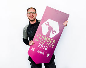 Steve Bartin holding Plumber Of The Year sign