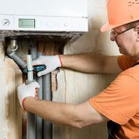 Plumber fixing boiler - Key signs your home utilities systems are on the way out