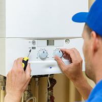 plumber servicing boiler to prevent carbon monoxide poisoning