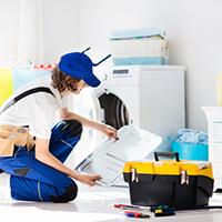 Apprenticeship plumber fixing washing machine