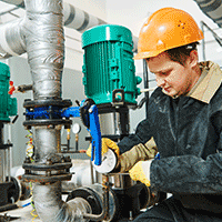 Man fixing a Together Energy heating pump
