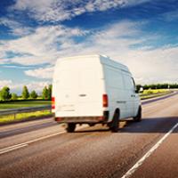 White van travelling down road White van travelling down road